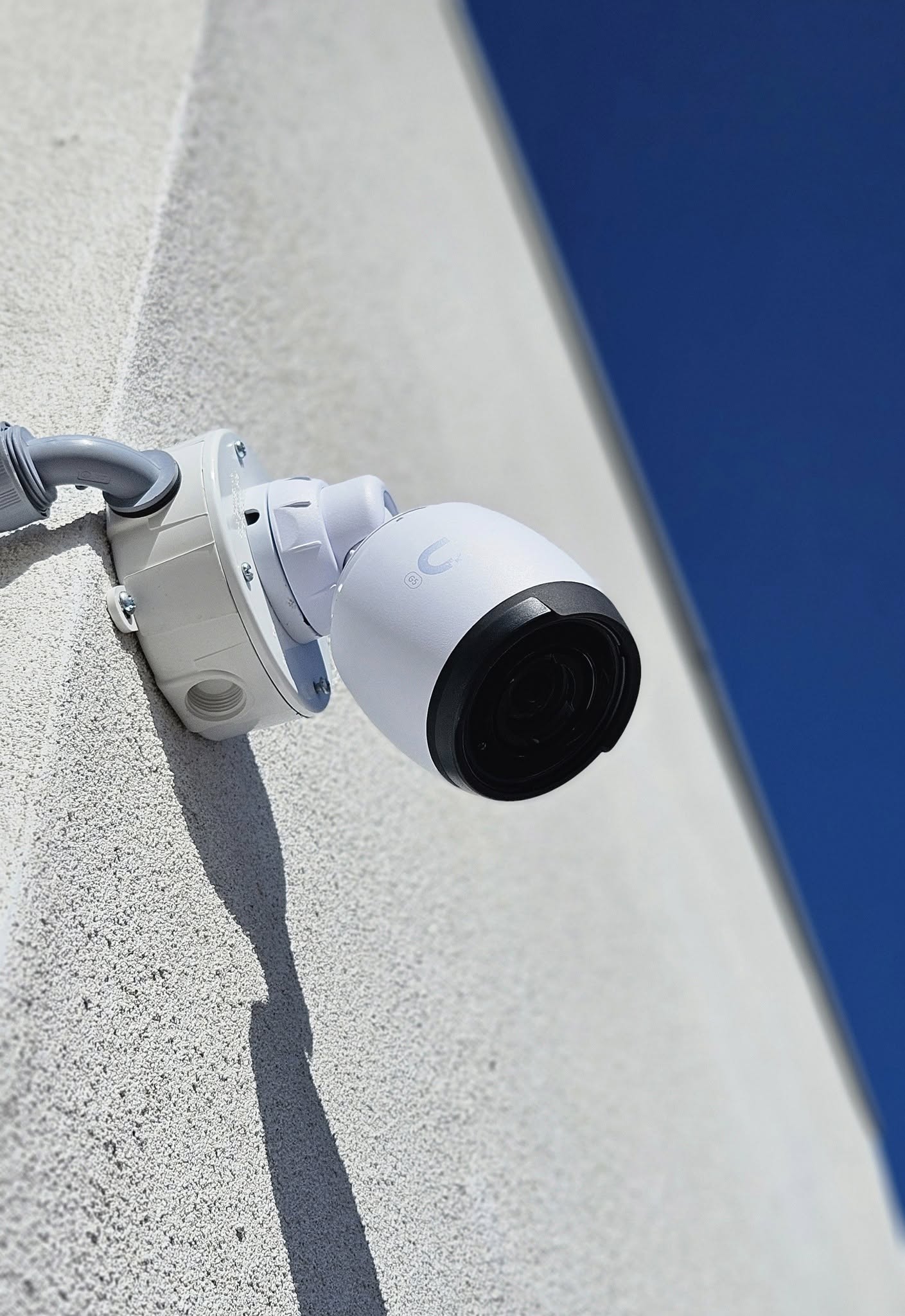 Professional white security camera mounted on building exterior